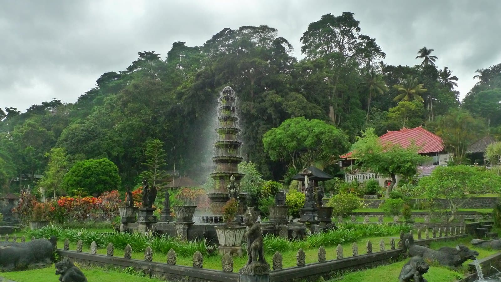 The tiered fountain and stone-edged pools of the Tirta Gangga water garden, the hills of Karangasem behind