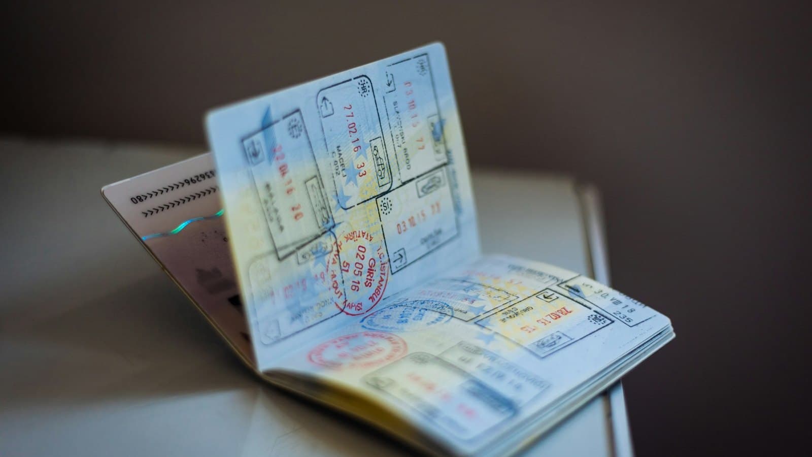 An open passport spread across two pages dense with entry and exit stamps