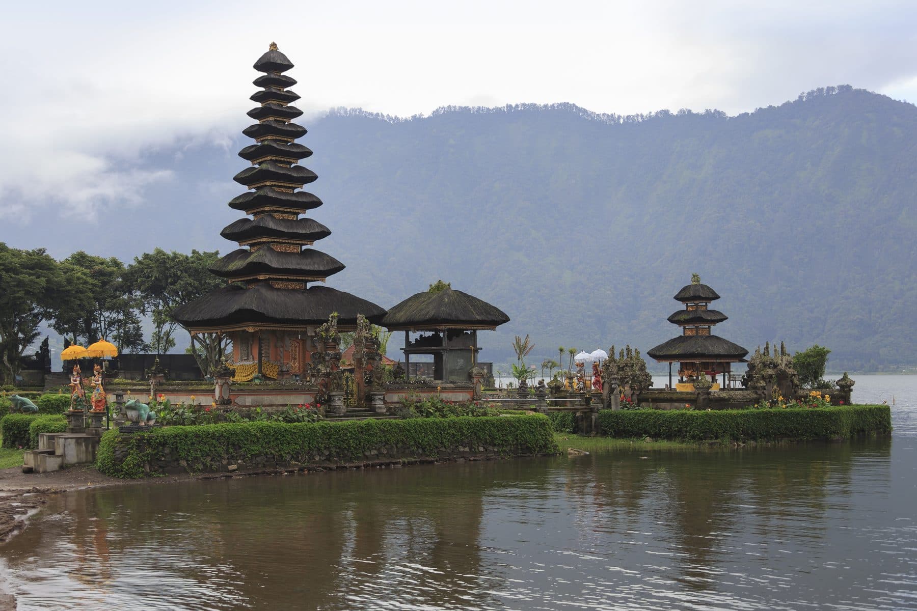 The Ulun Danu Beratan temple at Bedugul, its tiered roofs standing on the water of the lake with hills behind